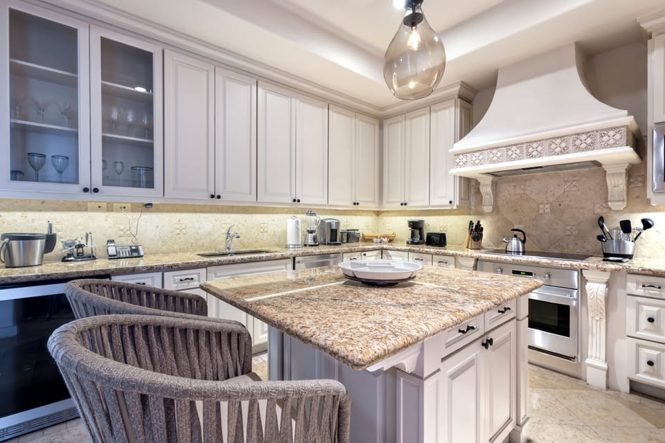 Your gourmet kitchen invites culinary adventures with gleaming granite countertops, professional appliances, and soft ambient lighting. Gather at the island for morning coffee or evening wine.