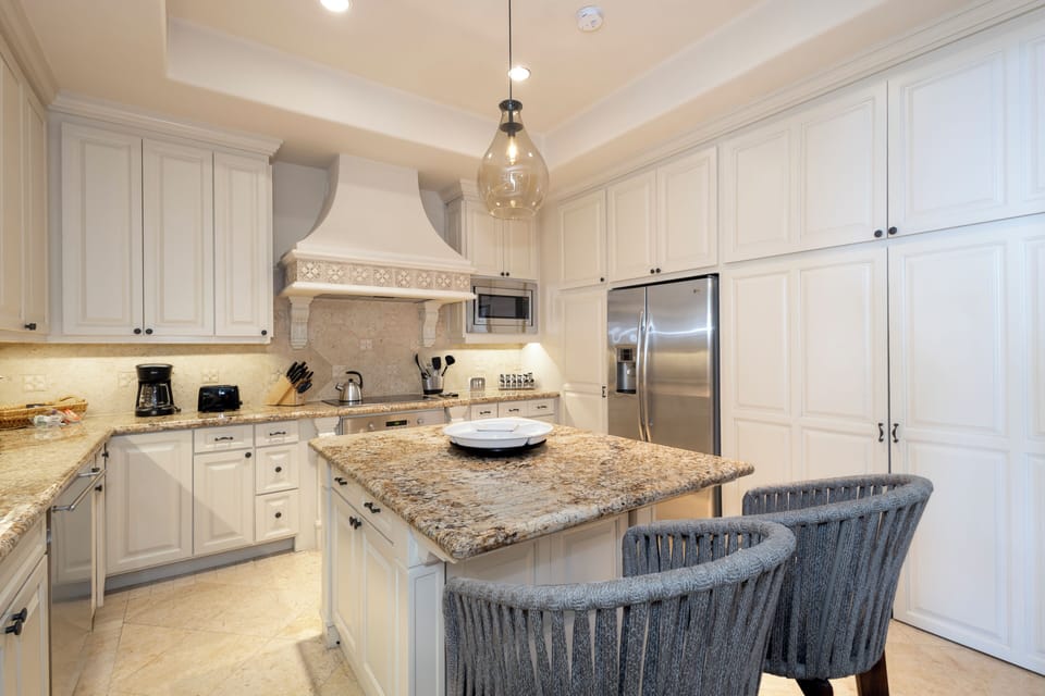 Step into your fully equipped chef's kitchen, where granite countertops, stainless steel appliances, and a spacious island invite you to create memorable meals together.
