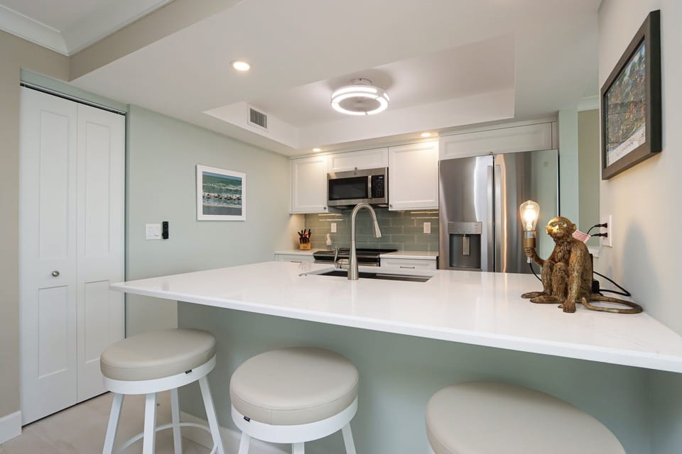 Kitchen with stainless steel appliances and breakfast bar