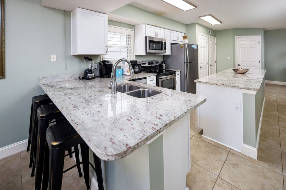 Kitchen - This spacious and updated kitchen has stainless steel appliances and granite. Enjoy some beach front cooking!