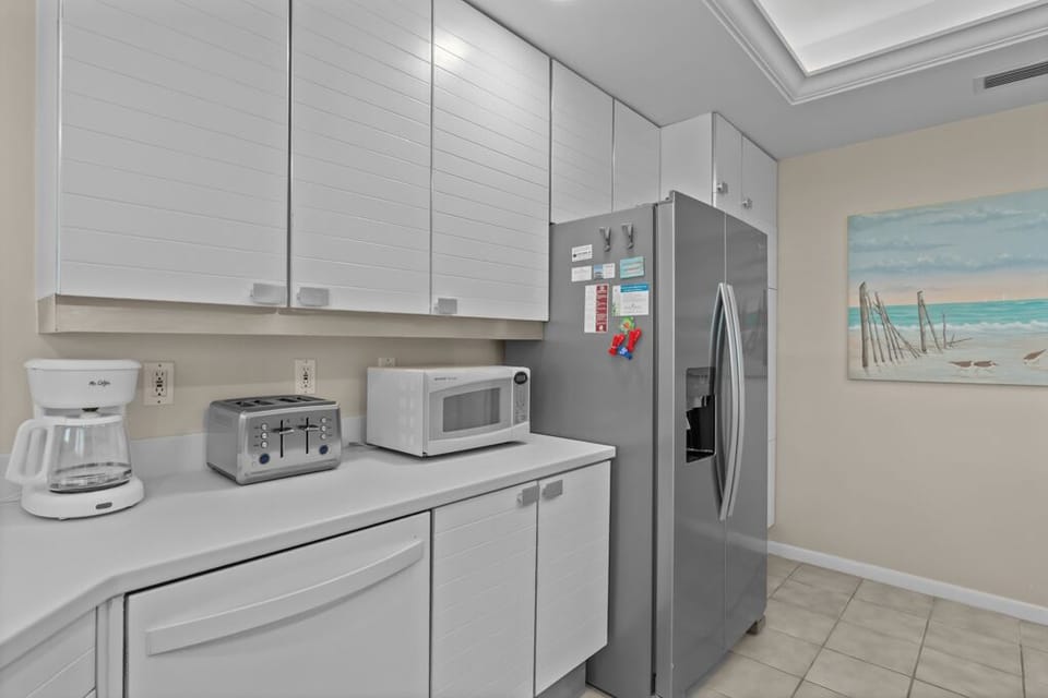 Kitchen with stainless steel appliances and breakfast bar