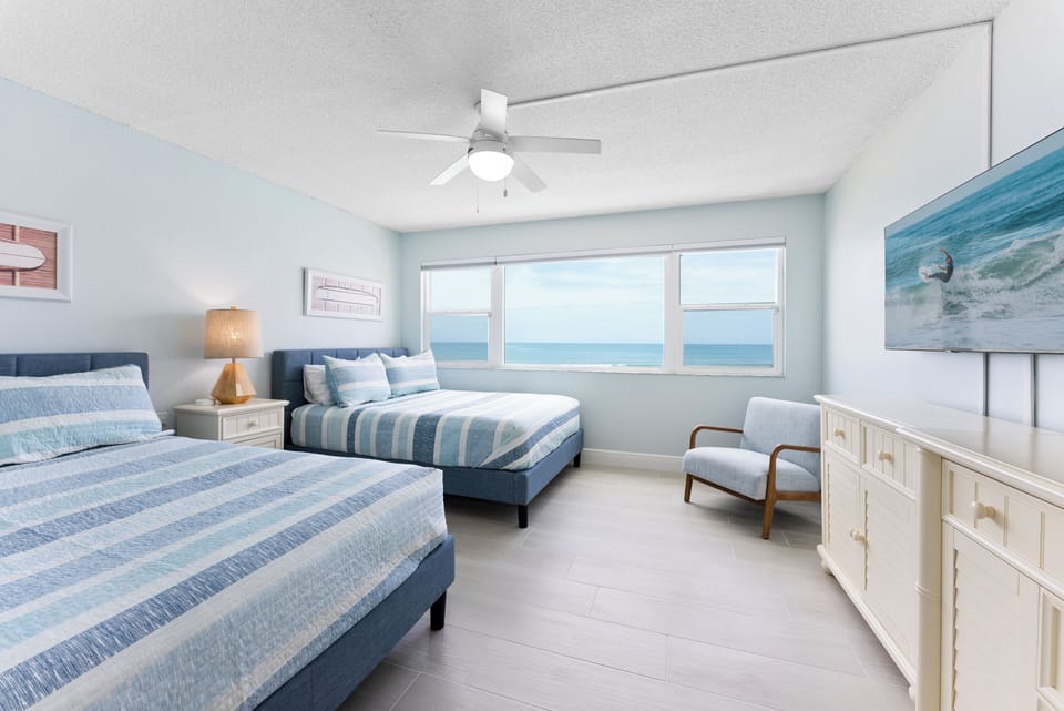 Wake up to the sound of waves in this spacious, well-lit bedroom with breathtaking ocean scenery.