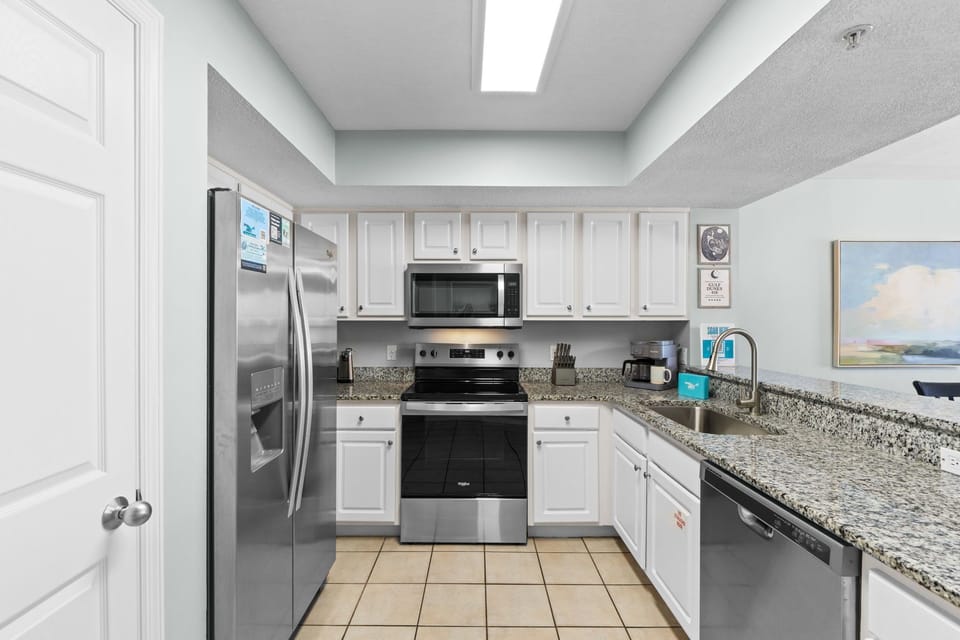 Kitchen - GRANITE countertops await the chef of the group in unit 416!