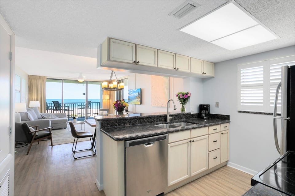 Sleek kitchen with granite countertops and stainless steel appliances