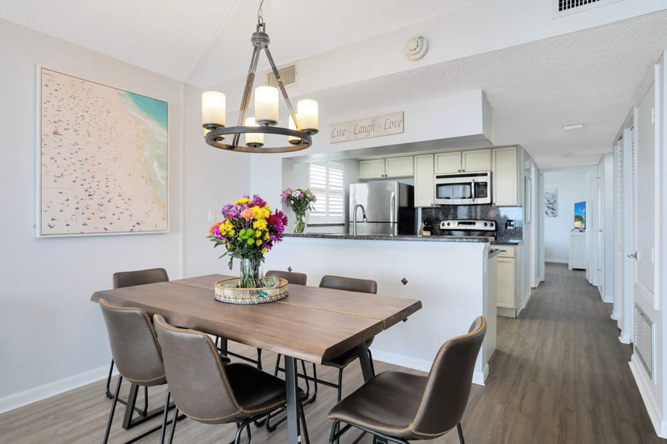 Elegant dining area with a modern chandelier and fresh floral centerpiece