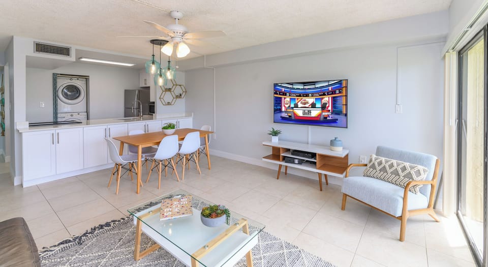 Stream your favorite shows in this sunny open space with comfy seating and a full view of the dining and laundry area.