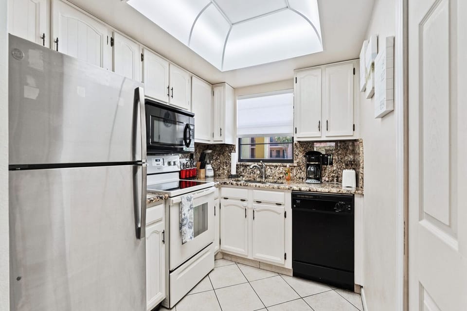 Fully equipped kitchen with stainless steel appliances and granite countertops.