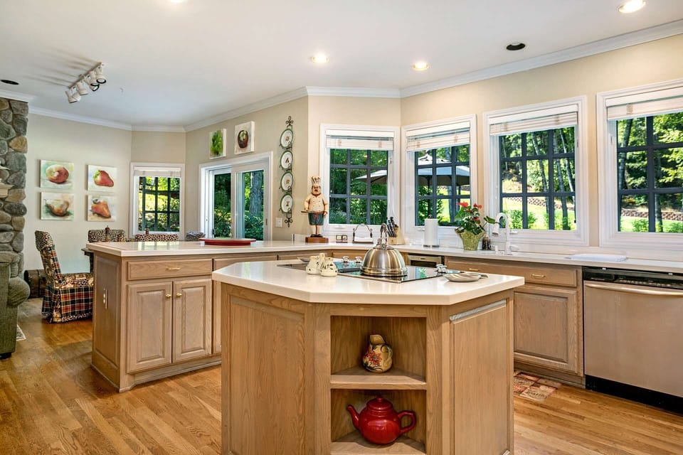 Fully equipped kitchen with views of beautiful backyard living space, bar seating for 2 and breakfast table.