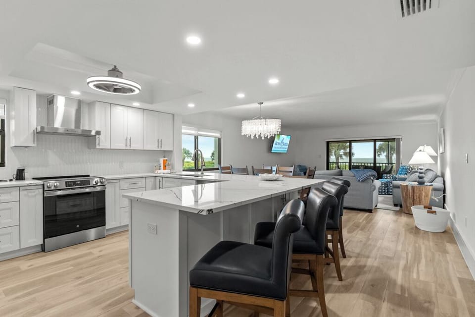 Modern kitchen featuring quartz countertops, stainless steel appliances, and a breakfast bar—ideal for easy island dining and entertaining