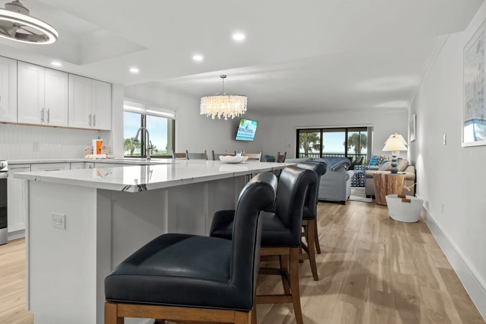 Modern kitchen featuring quartz countertops, stainless steel appliances, and a breakfast bar—ideal for easy island dining and entertaining