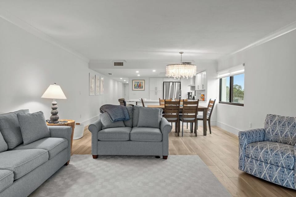 Bright and spacious living area with coastal décor, natural light, and comfortable seating—perfect for relaxing after a day on Sanibel's beaches