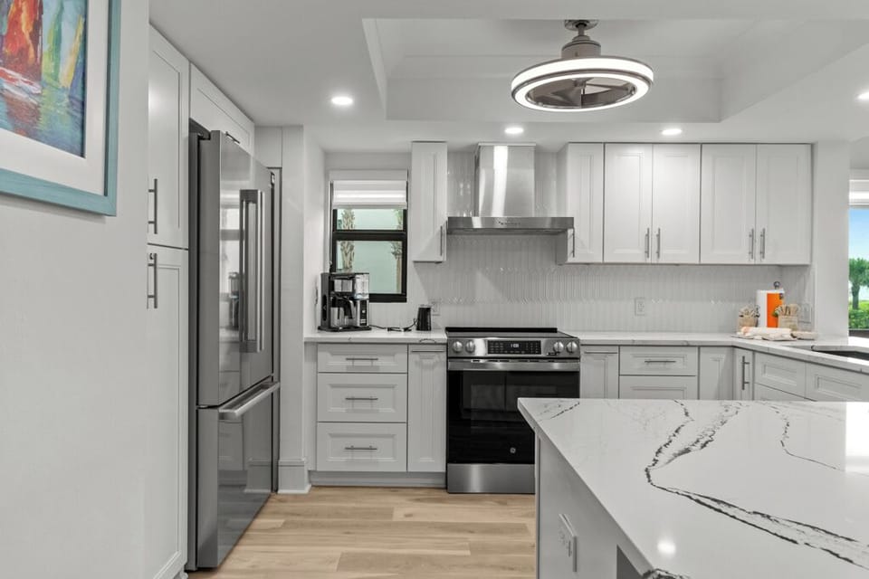 Modern kitchen featuring quartz countertops, stainless steel appliances, and a breakfast bar—ideal for easy island dining and entertaining