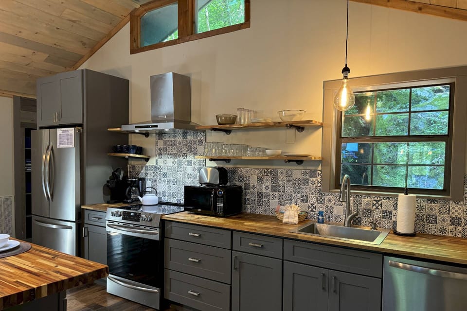 The modern kitchen boasts all your major stainless steel appliances, butcher block counters, and all the trimmings.