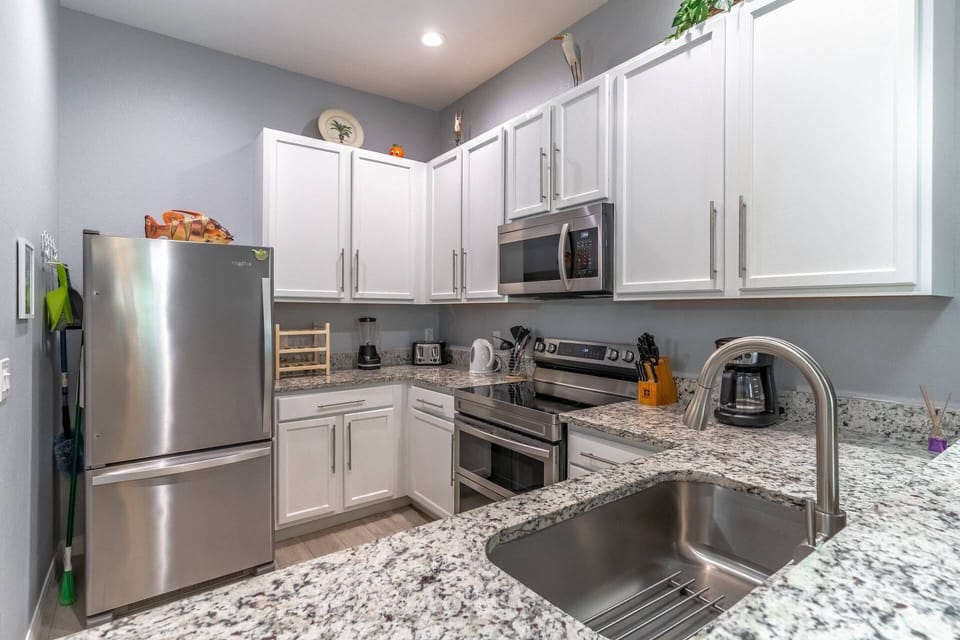 Fully equipped kitchen with granite counters and stainless steel appliances