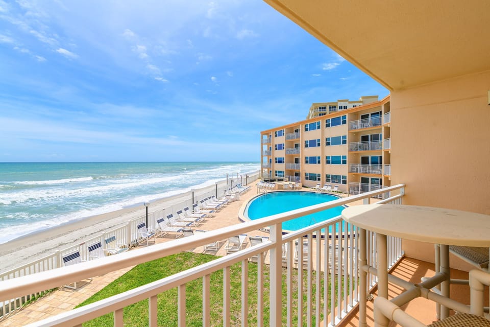 Step out onto the private balcony and take in the stunning ocean and pool views.