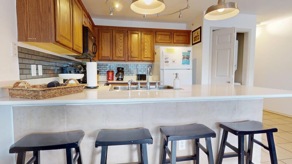 The kitchen with additional bar seating