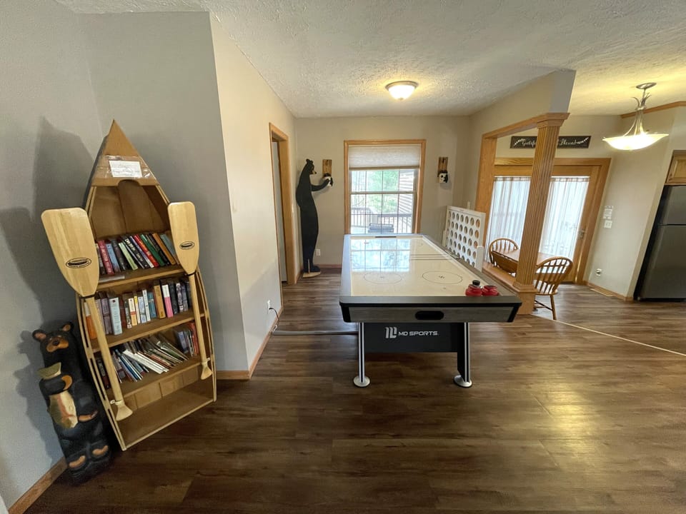 First Living Room with Cozy Seating, Queen Sofa Sleeper, Air Hockey Table & Giant Connect 4