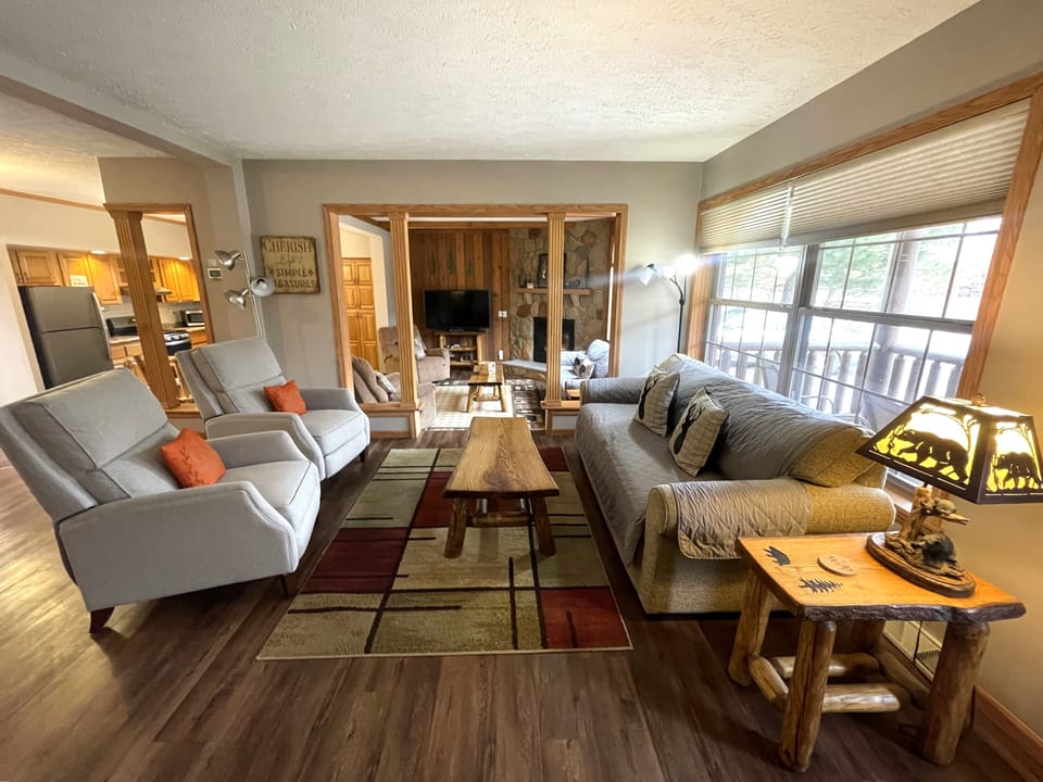 First Living Room with Cozy Seating, Queen Sofa Sleeper, Air Hockey Table & Giant Connect 4
