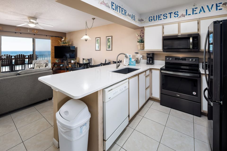 Kitchen - "ENTER as Guests, Leave as Friends" The kitchen island offers a perfect space for a quick sandwich, while the rest of the kitchen is equipped with all major appliances to make a healthy home cooked meal.