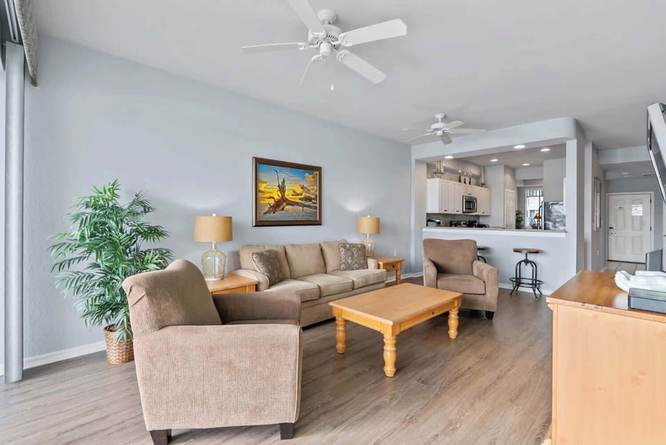 Living Room with Flat Screen TV, Fan, and Entrance to Lanai Area 