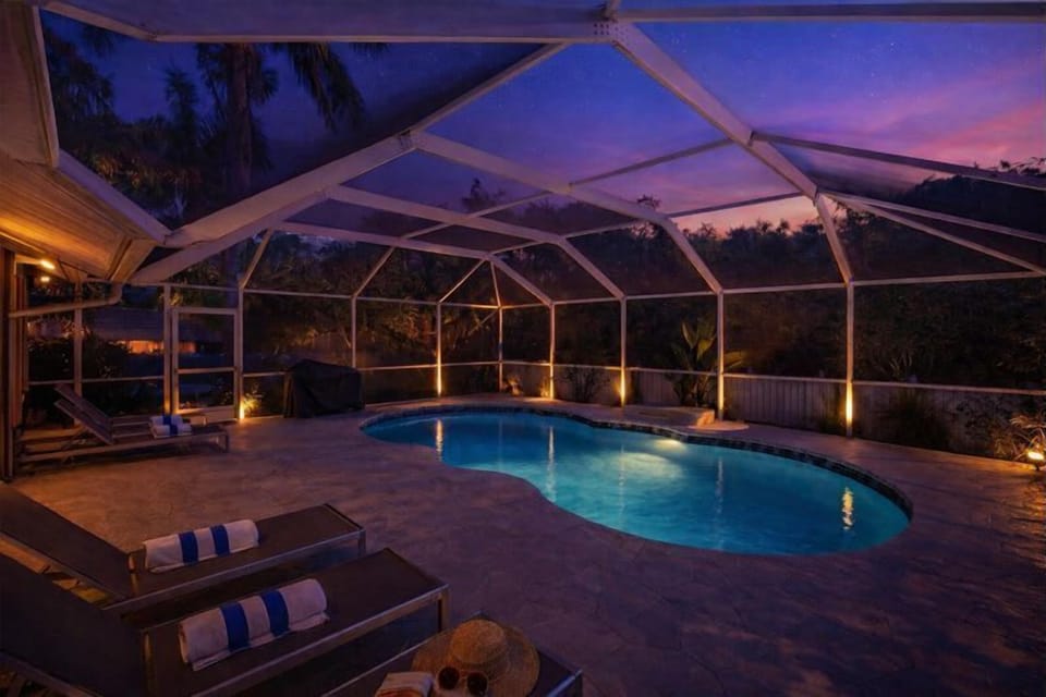 Private heated pool & spa glowing at sunset — your own tropical Naples retreat just minutes from the beach