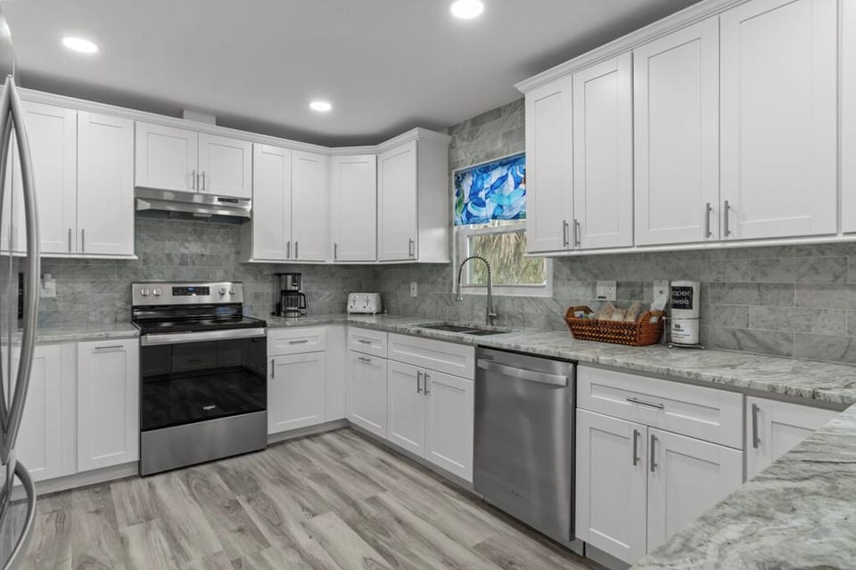 Modern kitchen with stainless steel appliances, granite countertops, and all the essentials for effortless vacation cooking.