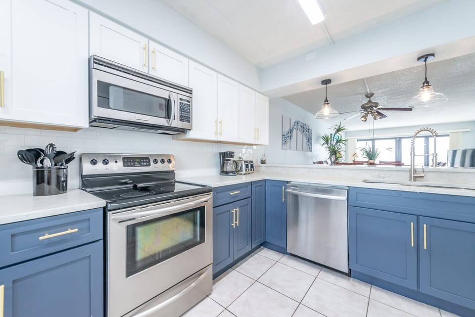Fully equipped kitchen with stainless steel  appliances & quartz countertops
