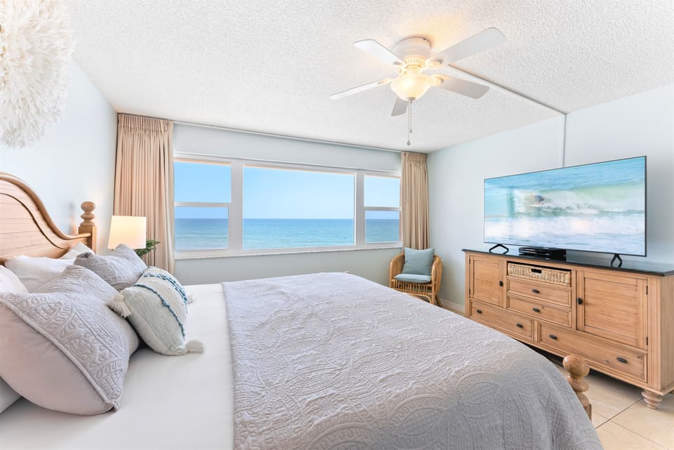 Wake up in a king-size bed wrapped in crisp, cool linens, with the ocean stretching before you