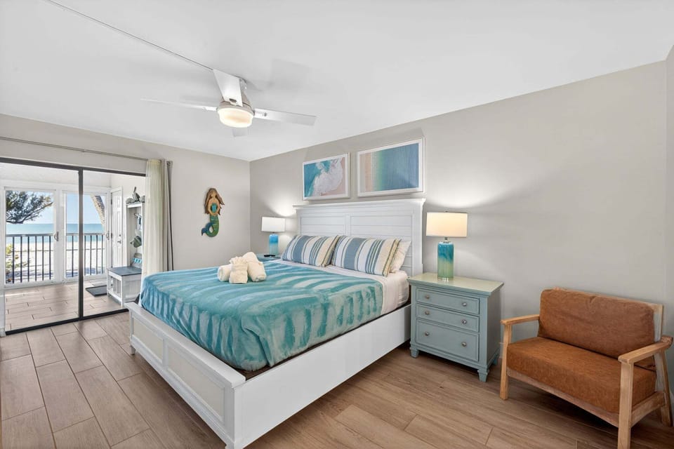Primary bedroom with slider access to lanai and Gulf views