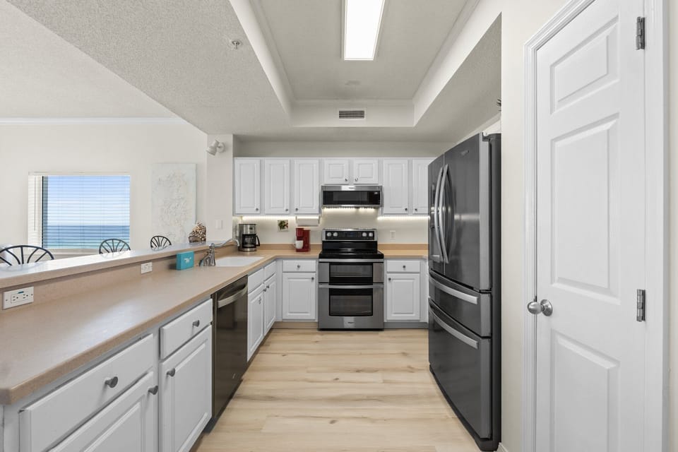 Kitchen - The kitchen is well stocked and includes stainless steel appliances.  Notice there is plenty of counter space for preparing your favorite meals.