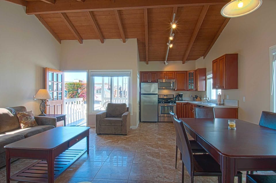 Inside photo showing family, kitchen & dining area