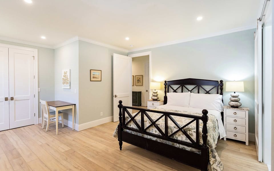 Queen Bedroom with queen bed, tv, writing desk and attached bathroom