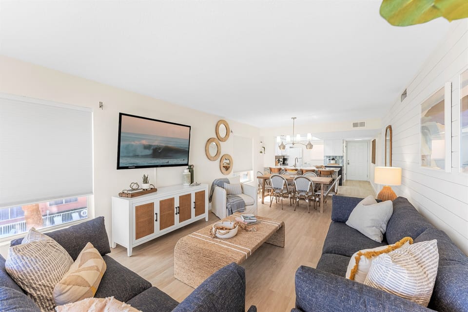 Living room featuring a sofa, smart TV with streaming apps, and bright design this space is perfect for movie nights,