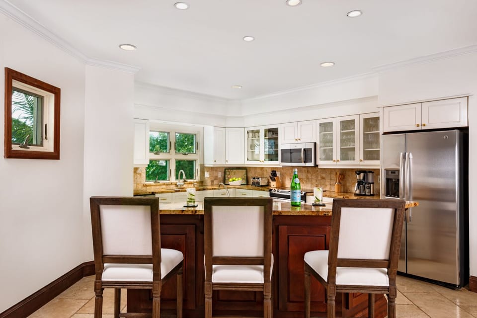 The kitchen has 3 pull up barstools and plenty of room to cook.