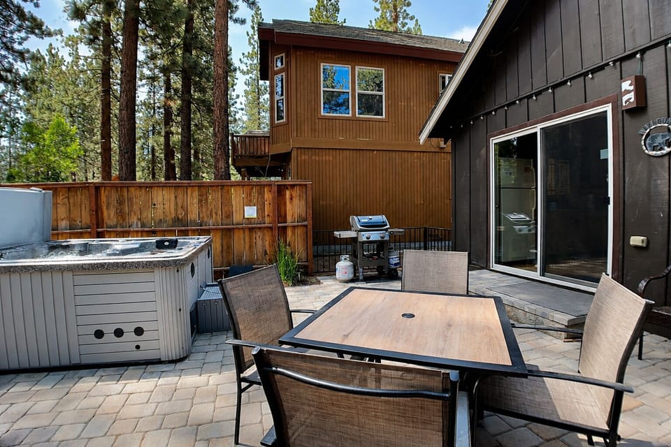 Your private outdoor retreat features a hot tub for soaking under the stars, a dining table for al fresco meals, and a BBQ grill ready for your mountain cookouts.