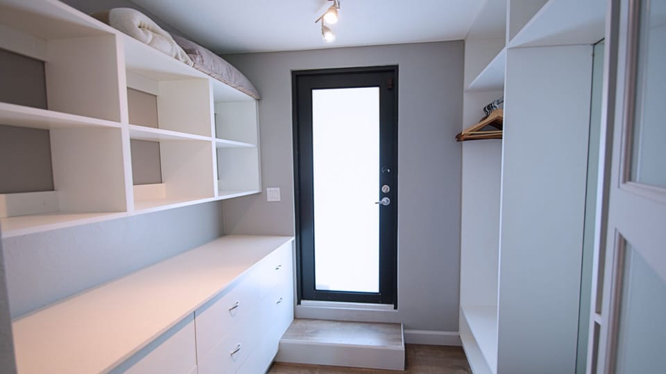 Walkin closet of master bedroom with door to open sun deck