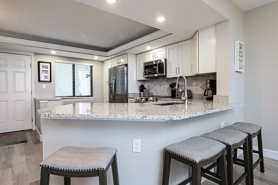 Kitchen with stainless steel appliances and breakfast bar