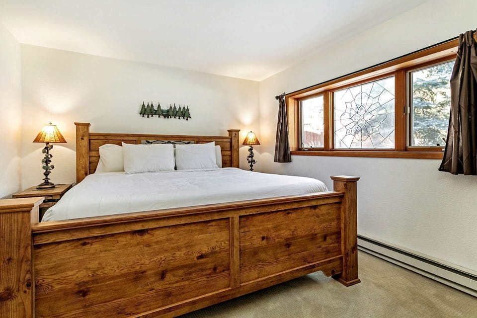 Venture downstairs to the master bedroom featuring a king bed.