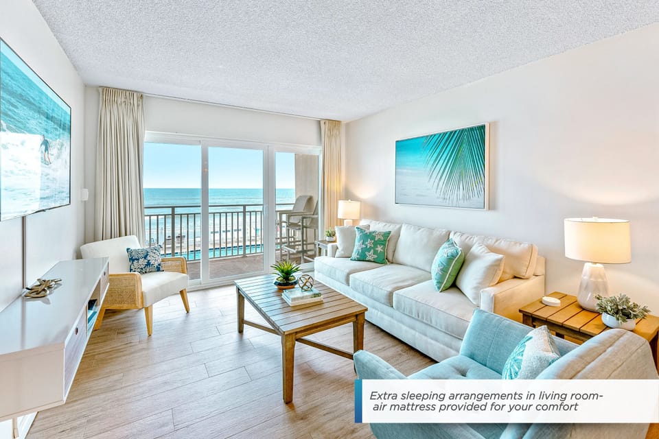 A stunning oceanfront living space with comfortable seating, and direct access to the balcony with breathtaking views. Air mattress is provided.