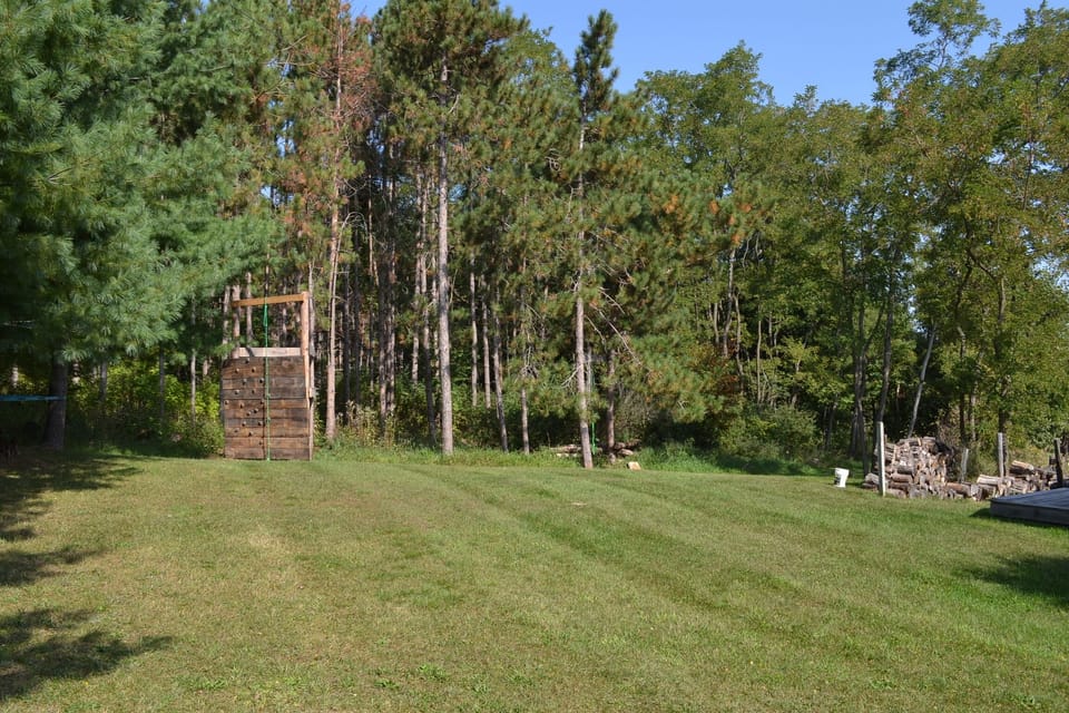 Outdoors - Yep that's a climbing wall. Deck/patio, Grill, Lawn/garden, Outdoor play area, Badminton, Climbing wall, Hammock, Firepit, Mini baseball field, Outdoor games, Outdoor shower, Porch, Near lake, Exceptional views.