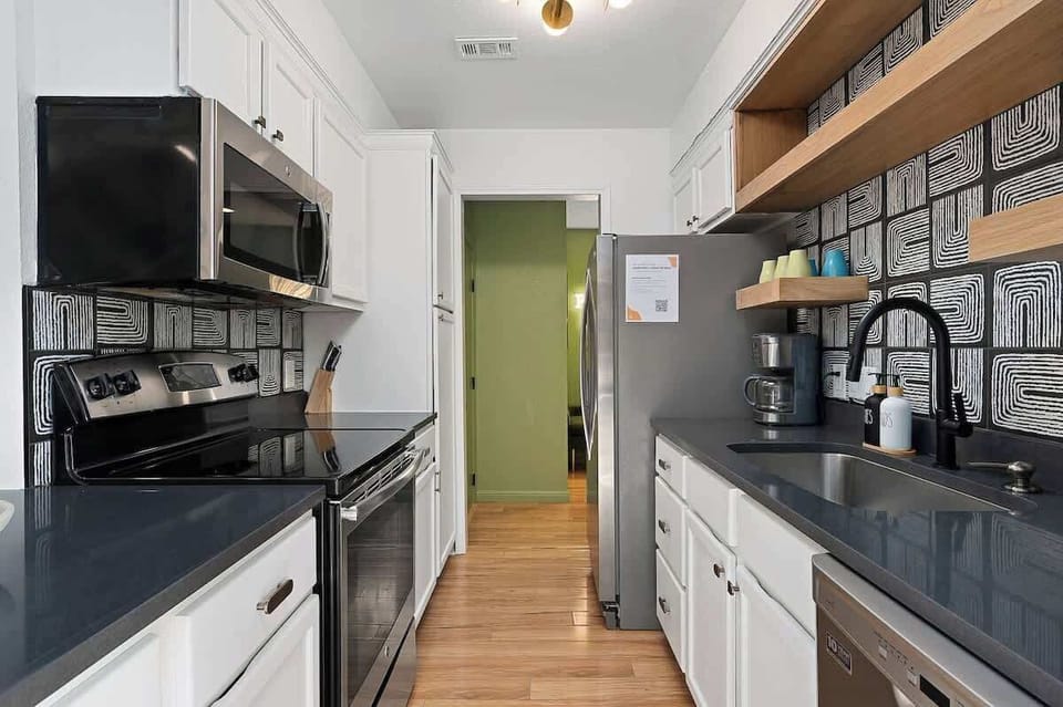Unit A - Fully updated kitchen with quartz counter tops and stainless steel appliances.