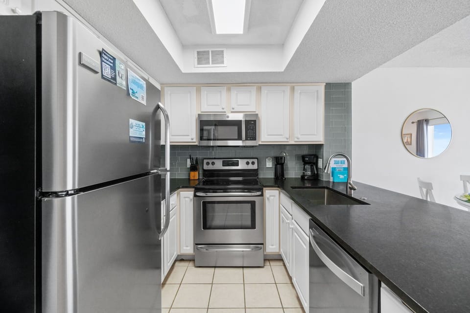 Kitchen - Stainless steel appliances & great lighting makes this kitchen easy to work in.