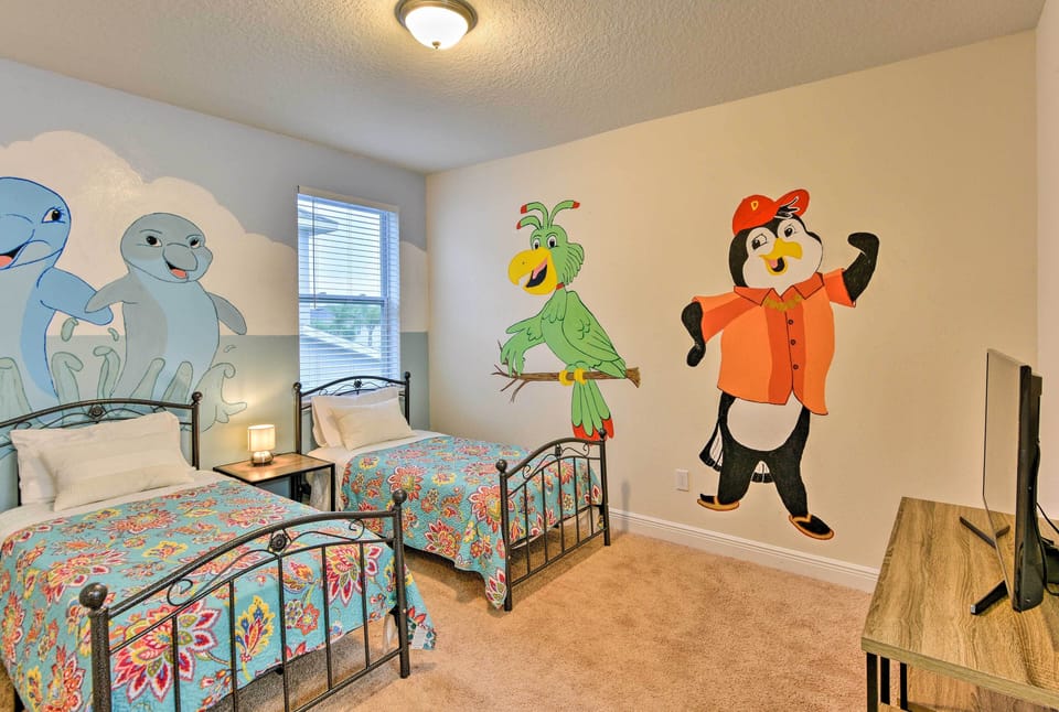 Kids will love sleeping in this cartoon-themed bedroom with 2 twin beds.