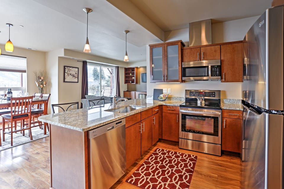 Prepare meals in the fully equipped kitchen with stainless steel appliances.
