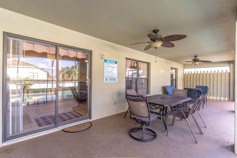 Backyard oasis with dining seating, lounge seating fenced pool and a yard with privacy fence!