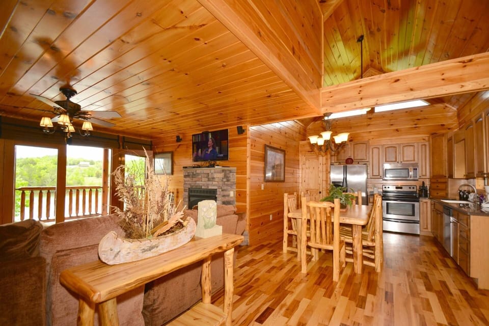 Open area living room with Flat Screen TV, Gas Fireplace and Well-Equipped Kitchen