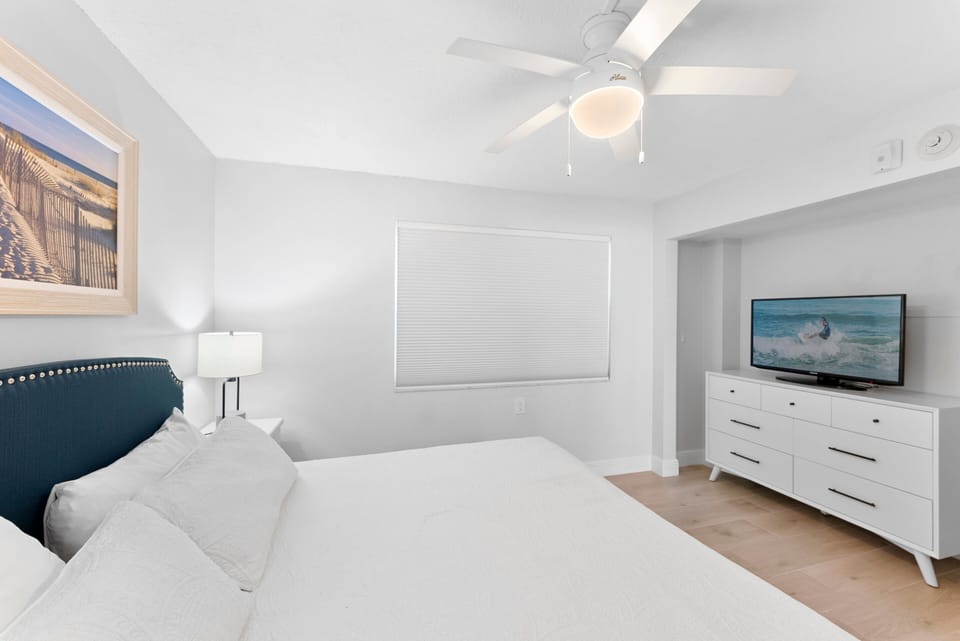 Comfortable and stylish bedroom with a TV and  plush bedding