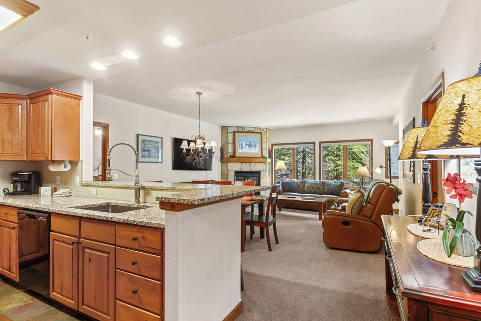 Spacious open layout connects your kitchen, dining, and living areas—perfect for gathering with loved ones. Natural light pours through large windows framing peaceful greenery.