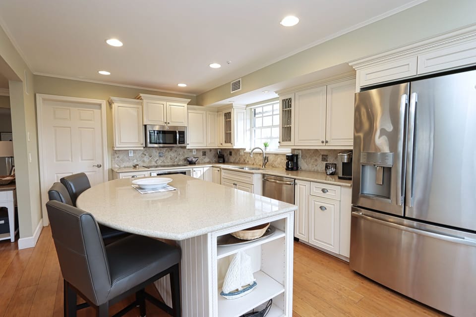 Kitchen with stainless steel appliances and breakfast bar