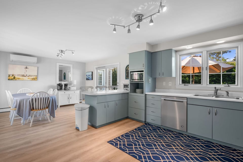 Spacious kitchen and dining area with access to the deck and views of the backyard - 13 Monomoy Circle Chatham Cape Cod - BreakAway - NEVR